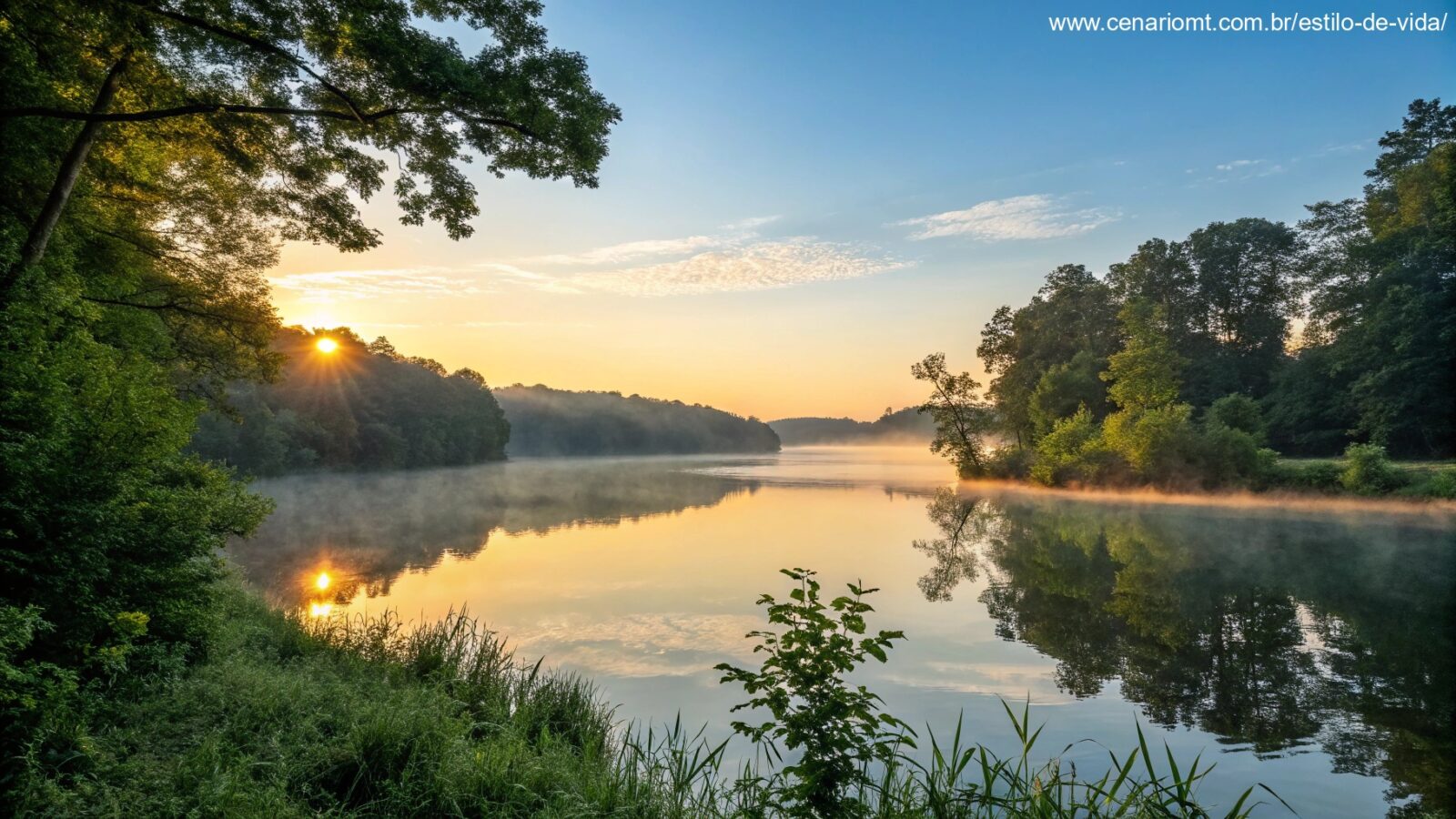 Nascer do sol sereno sobre um lago calmo com luz dourada refletindo na água, cercado por árvores verdes e um céu azul claro, evocando uma sensação de paz e bênção para uma sexta-feira de manhã.