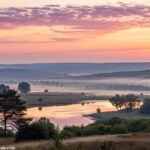 Paisagem serena ao amanhecer, com cores suaves e uma atmosfera de paz, simbolizando reflexão e fé.