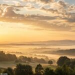 Imagem serena de um amanhecer sobre uma paisagem tranquila, simbolizando esperança e espiritualidade para a manhã de sexta-feira.