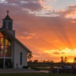 Imagem de um amanhecer sereno sobre uma igreja, com raios de luz passando pelas janelas de vitral. Um grupo de pessoas está reunido em um ambiente espiritual e calmo.