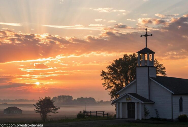 Uma imagem de um amanhecer tranquilo sobre uma igreja, com raios suaves de luz iluminando uma cruz, simbolizando esperança e renovação.