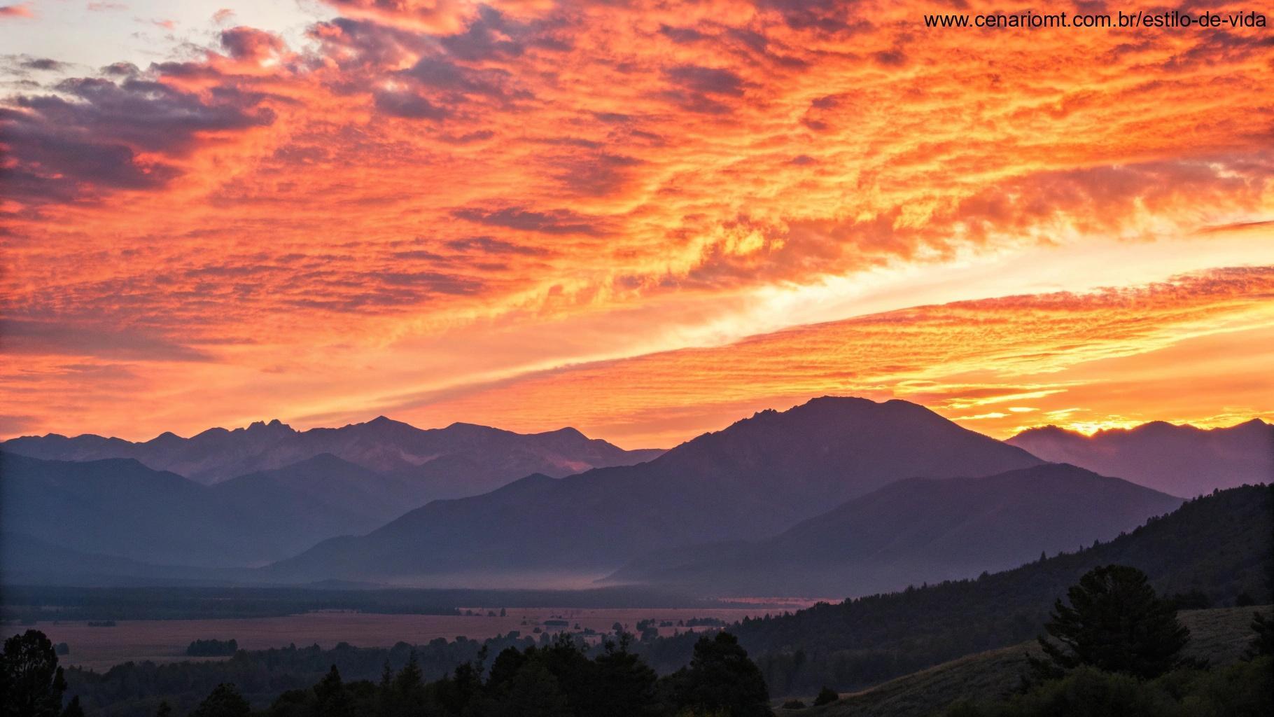 Um amanhecer vibrante sobre uma cadeia de montanhas, irradiando energia positiva e calor, simbolizando boas energias para o sábado.