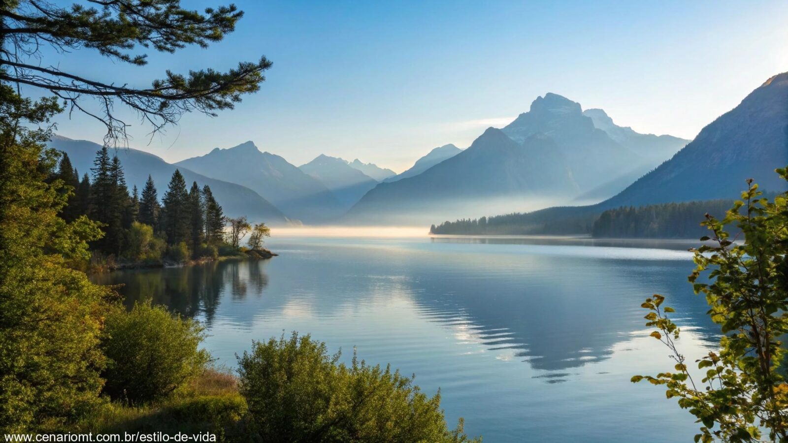 Paisagem serena com um lago tranquilo rodeado por montanhas sob um céu claro, simbolizando calma e reflexão.