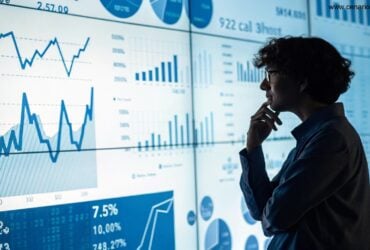 Pessoa pensativa analisando gráficos matemáticos em uma tela digital com tons de azul e branco.