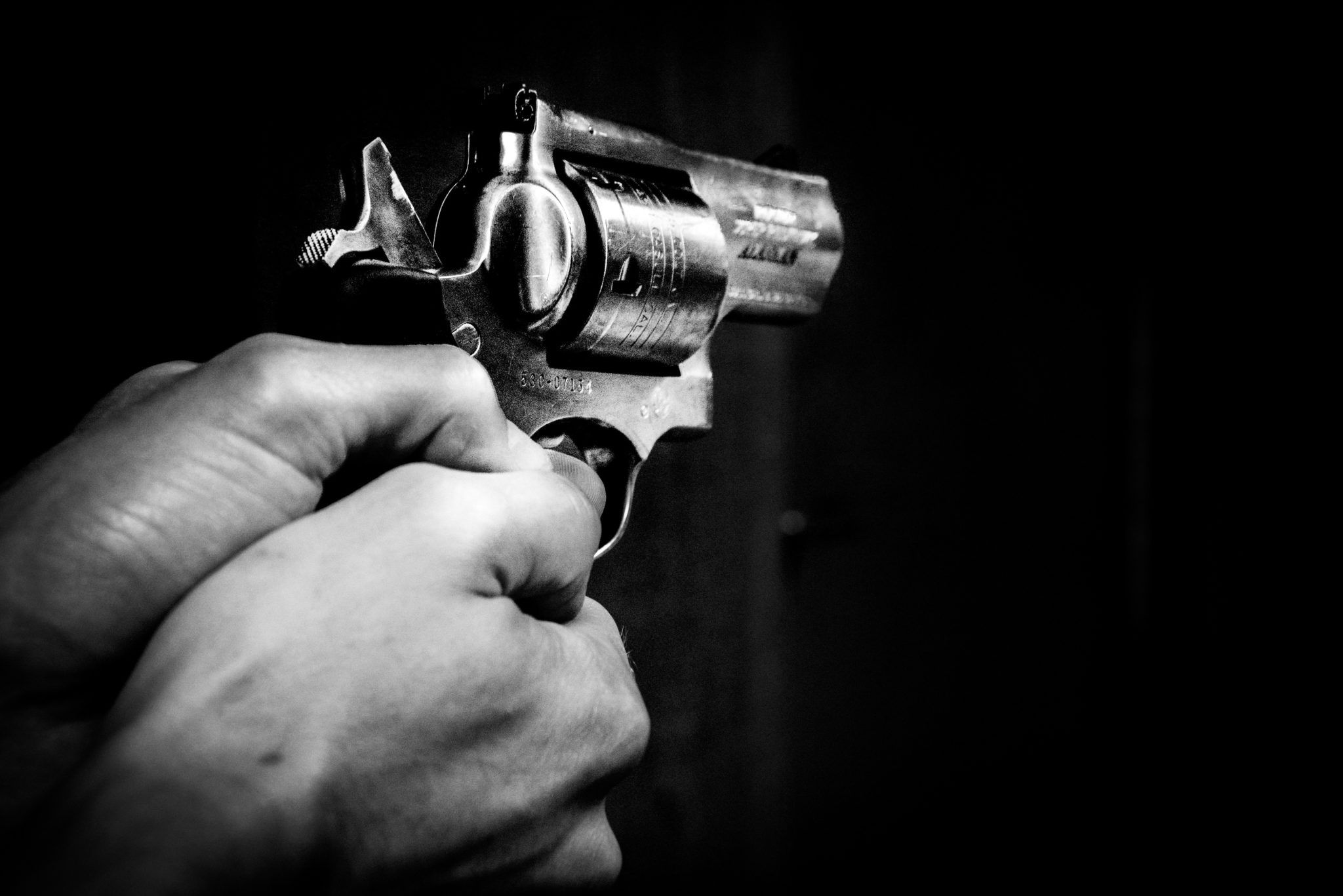 man shooting revolver gun