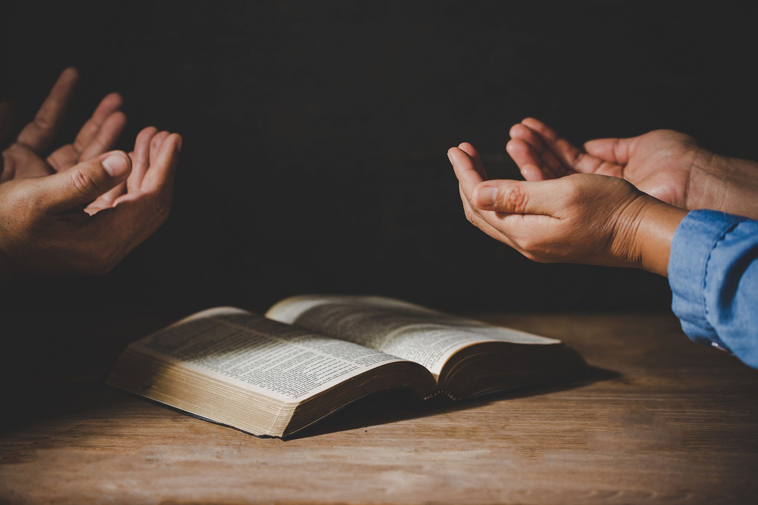 group of people holding hands praying worship believe scaled