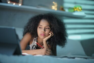 Mulher negra cansada estudando em casa com o laptop - Fotos do Canva