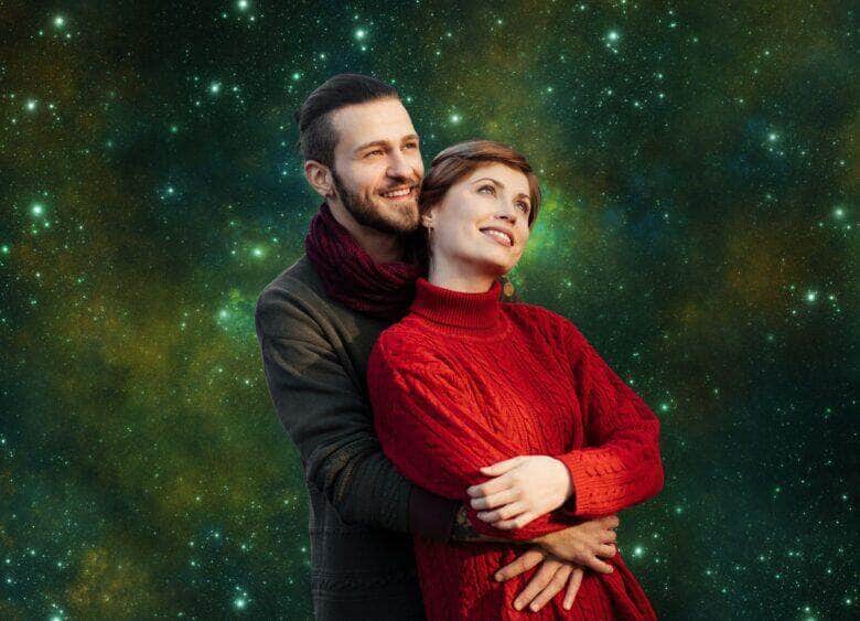 Casal apaixonado trocando olhares ao pôr do sol, representando a intensidade romântica dos signos até domingo.