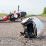 Foto do capacete e da motocicleta na estrada, o conceito de acidentes rodoviários - Fotos do Canva