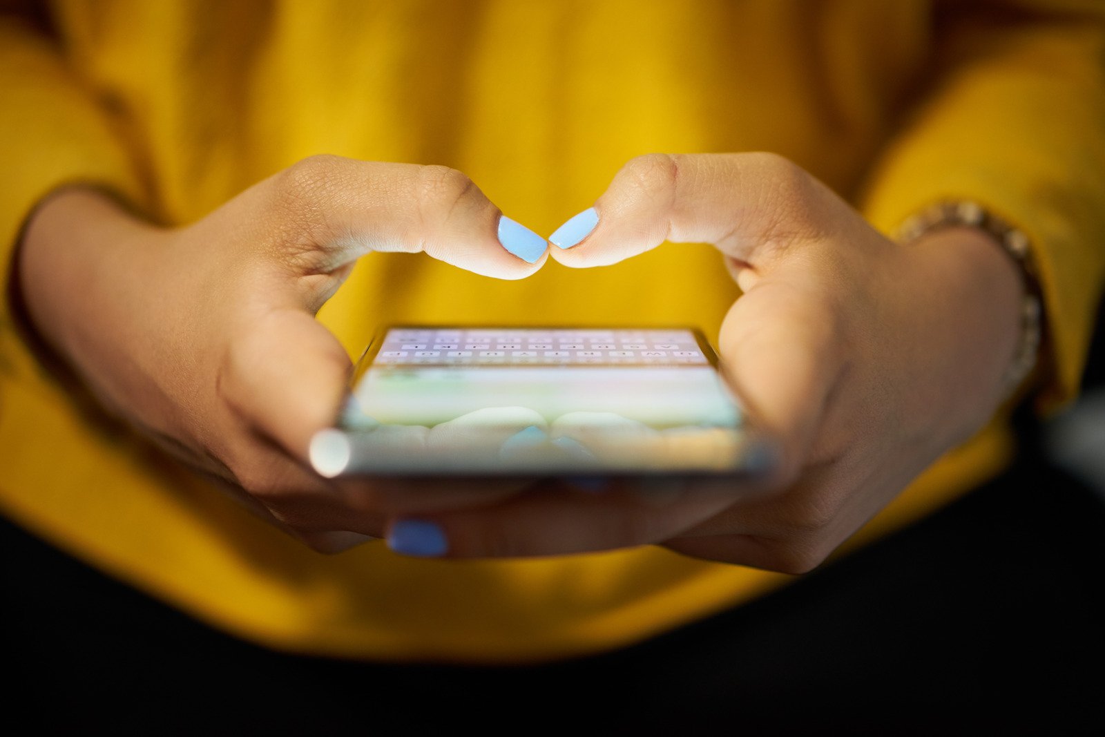 Mulher digitando mensagem de telefone na rede social à noite - Fotos do Canva