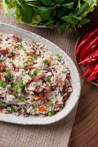 Arroz de Carreteiro - Typical food from southern Brazil, made with rice, dried meat, pepperoni sausage, bacon and carrots. Top view. Copy space - Fotos do Canva1 (1)