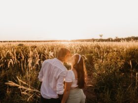 Casal apaixonado beijando no vasto campo ao pôr do sol - Fotos do Canva