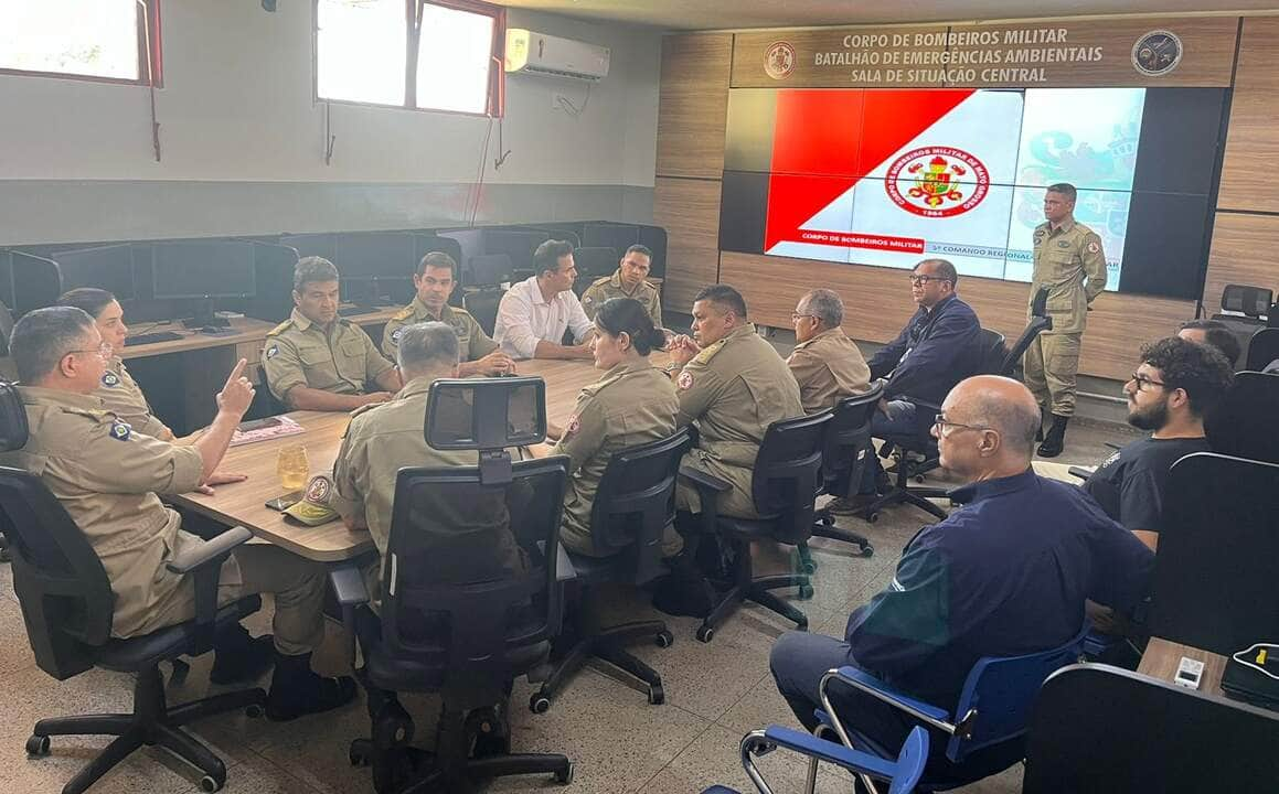 O Corpo de Bombeiros Militar de Mato Grosso criou um grupo de trabalho para avaliar a expansão do aplicativo "Chama o Bombeiro" para outros municípios além de Cáceres, com o objetivo de proporcionar um atendimento emergencial mais inclusivo para pessoas surdas em todo o Estado. O aplicativo, que melhora significativamente a comunicação durante emergências, foi apresentado a autoridades civis e militares, nessa terça-feira (30.04), em reunião na Sala de Situação Central do Batalhão de Emergências Ambientais (BEA). Desenvolvido em colaboração com o 5º Comando Regional de Bombeiros Militar (CRBM) e o Centro de Inovação Redes Inteligentes e Soluções Criativas (Risc - Unemat), o "Chama o Bombeiro" está atualmente disponível apenas na cidade de Cáceres. Com a formação do novo grupo de trabalho, liderado pelo comandante-geral do CBMMT, Alessandro Borges, há intenção de expandir o uso do aplicativo. “Essa iniciativa visa levar os benefícios do 'Chama o Bombeiro' para um número ainda maior de pessoas, garantindo um atendimento eficiente e inclusivo em todo o Estado de Mato Grosso”, explicou o comandante-geral do Corpo de Bombeiros. A apresentação da ferramenta às autoridades foi conduzida pela equipe responsável pelo desenvolvimento do aplicativo, que inclui a coronel BM Luciana Bragança, o major BM Leandro Jorge de Souza, e os professores Robson Gomes de Melo e Nivaldi Calonego Junior. Eles demonstraram como a plataforma permite que usuários surdos comuniquem suas emergências visualmente, enviando vídeos ou fotos que detalham o ocorrido. Os recursos do aplicativo facilitam o envio de informações e registram automaticamente a localização exata do incidente, acelerando a resposta dos bombeiros. O superintendente do Centro Integrado de Operações de Segurança Pública (Ciosp), delegado Cláudio Alvarez Sant'Ana, pontuou que a inovação trazida pelo aplicativo traz eficiência aos serviços. “Ao eliminar a necessidade de comunicação oral no atendimento às ocorrências, o aplicativo oferece um modelo visual de atendimento que se mostra mais eficiente, representando um avanço significativo no atendimento de emergências”, destacou o superintendente. A plataforma desenvolvida por servidores da Universidade do Estado de Mato Grosso (Unemat) ficou em 1° lugar no Prêmio de Eficiência e Inovação em Práticas Públicas, na categoria satisfação do cidadão ou servidor. A premiação ocorreu no dia 15 de abril e reconheceu 10 iniciativas de eficiência no serviço público estadual.