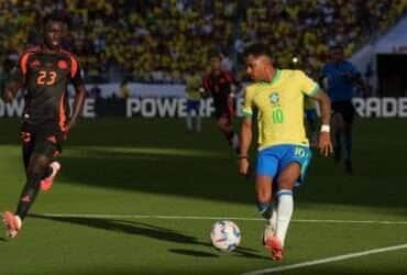 Jul 2, 2024; Santa Clara, CA, USA; Colombia midfielder James Rodriguez (front) shoots against Brazil midfielder Bruno Guimaraes (back) during the first half at Levi