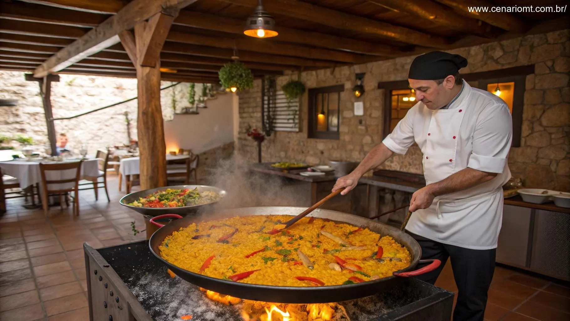 Chef preparando uma Paella Valenciana em uma grande panela sobre o fogo, com arroz amarelo e ingredientes coloridos.